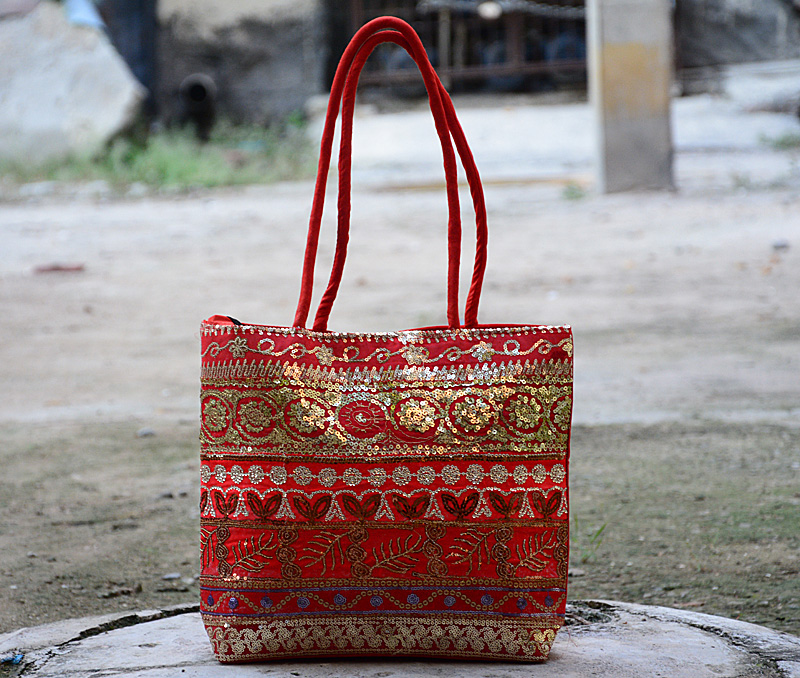 Vogue Crafts & Designs Pvt. Ltd. manufactures Embroidered Red Bag at wholesale price.