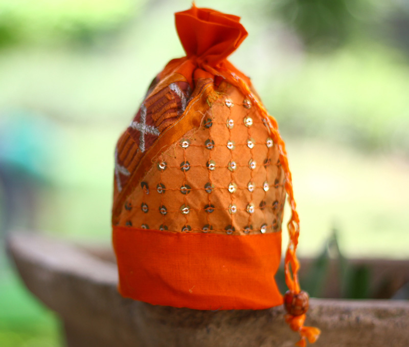 Vogue Crafts & Designs Pvt. Ltd. manufactures Orange Potli Bag at wholesale price.