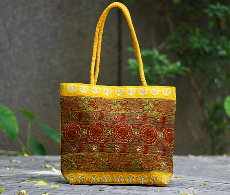Vogue Crafts & Designs Pvt. Ltd. manufactures Yellow Embroidered Bag at wholesale price.
