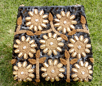 Vogue Crafts & Designs Pvt. Ltd. manufactures Black Sunflower Clutch at wholesale price.