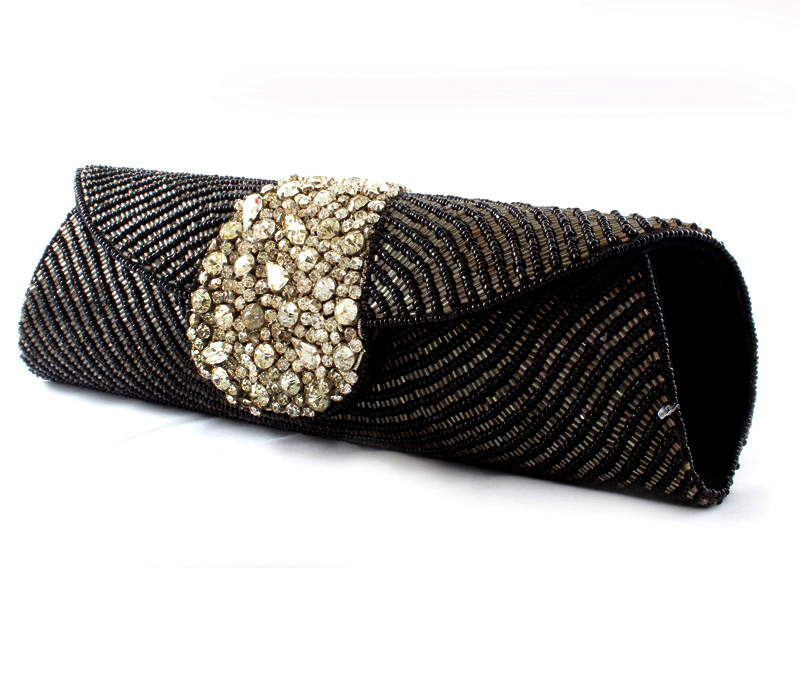 Vogue Crafts & Designs Pvt. Ltd. manufactures Dots of Black and Silver Clutch at wholesale price.