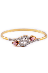 Vogue Crafts and Designs Pvt. Ltd. manufactures Golden Bracelet with Pink Trumulin stones at wholesale price.